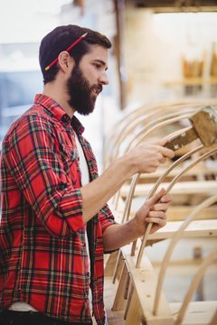 Man preparing wooden boat frame