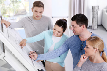 Obraz premium Team of young creative engineers working with new architectural project in office