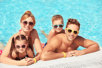 Happy family in swimming pool at water park