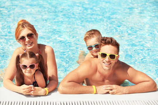 Happy family in swimming pool at water park