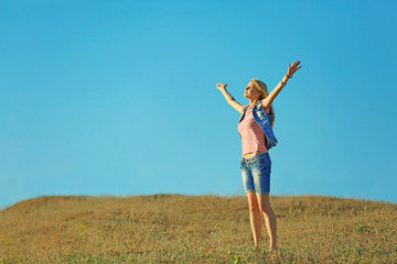 Happy young woman on blue sky background