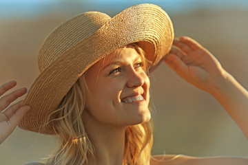 Portrait of young woman in straw hat