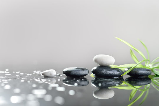 background of a spa with stones, and green leaves