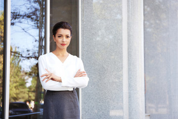 Beautiful businesswoman near office