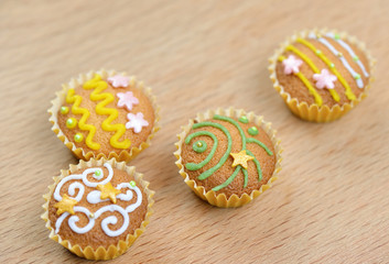 Photo of delicious decorated cupcakes on wooden background