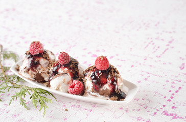 Food background. Scoops of ice cream with raspberries and jam.