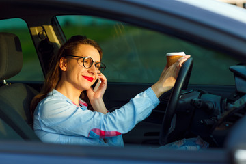 Businesswoman multitasking while driving