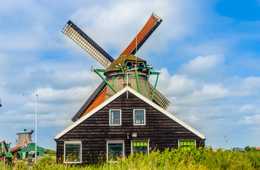 Rear view on old windmill over roof