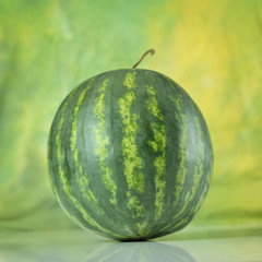Fresh juicy watermelon against green background