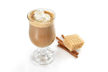 Top view of hot latte in glass with cream