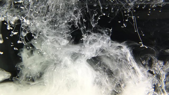 White Ink Effect In Water Filmed On Black Background. Abstract ink creating wonderfully unique cloud formations. Great for luma mattes or alien environments. Filmed in 4K for super Hi Def 