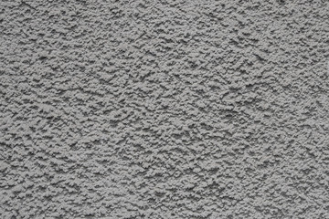 Gray bumpy concrete wall texture as a background