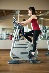 Fototapeta premium Woman working out on a stationary bike