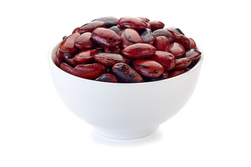 Bowl with black pinted red beans on white.