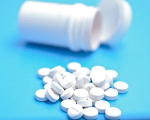 white pills on a blue background