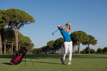 golf player hitting long shot