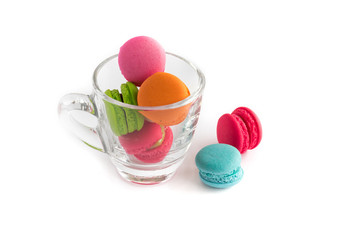 French macarons colorful on glass cup with white background, swe