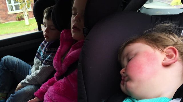 3 Children Fast Asleep In Car After A Long Drive Back From Holiday.