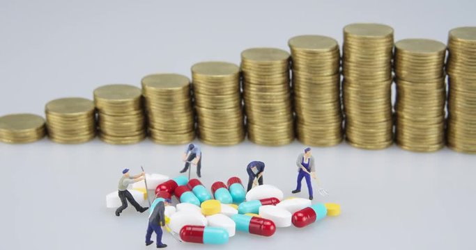 Medicine pill with miniature and gold coins step time lapse