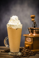 Iced coffee cafe latte with cream on the vintage wood