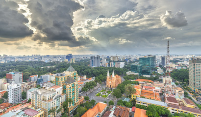 Obraz premium Ho Chi Minh City, Vietnam - October 2nd, 2016: Panorama Notre Dame cathedral Beauty buildings over a hundred years old, so far is high buildings for Economic Development in Ho Chi Minh City, Vietnam