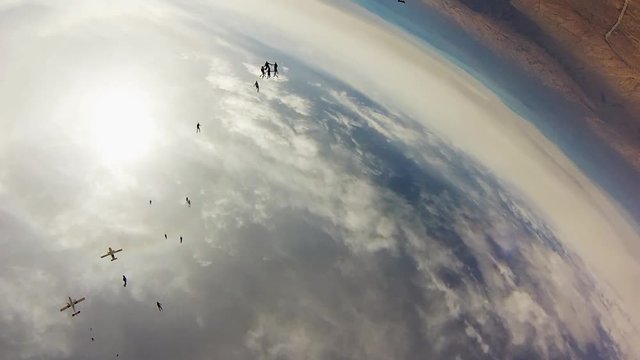 Team of skydivers making formation in sky. Height. Extreme activity. Stunt. Adrenaline