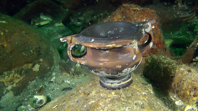 Greek dishware - kantharos among the amphora on the sea bottom (Black-glazed ware).
