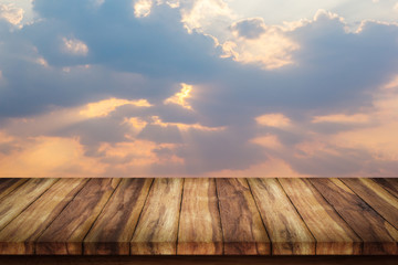 Wood table with beautiful sunset and clouds.