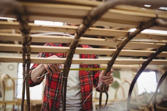 Man preparing a wooden boat frame