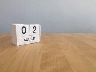 August 2nd.August 2 white wooden calendar on wood background.Sum