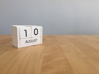 August 10th.August 10 white wooden calendar on wood background.S