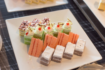 different dessert cakes in white dish