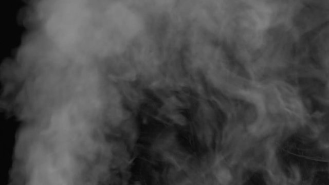 Real white steam looking like smoke isolated on black background. Clouds of white fantasy smoke abstract magic mystic fog toxic gas fumes pollution. Slow motion. Camera locked down. Recorded in 60fps