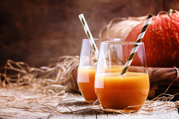 Pumpkin juice in glasses, decorations in the country style. Old