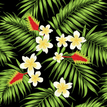 Tropical seamless pattern with palm leaves and exotic flowers. Green, white, yellow and red on black background.