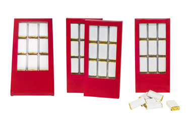 isolated chocolate sweets with white labels in red box on white background