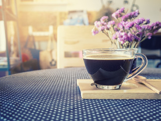 Coffee cup on table with flower decoration Vintage Tone