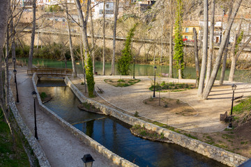 Small water canal crosses the city of Cuenca, Spain