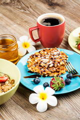 Cup of coffee and pastry on wooden background