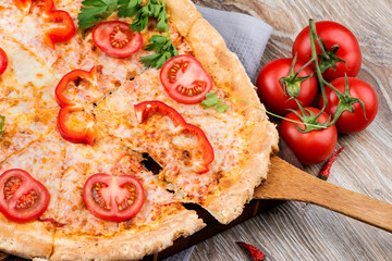 Hot pizza on wooden background