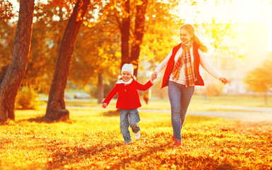 happy family mother and child little daughter on autumn walk