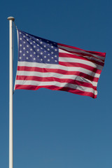 American flag on the blue sky waving