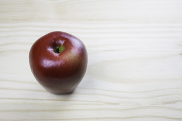 red apple on wooden table