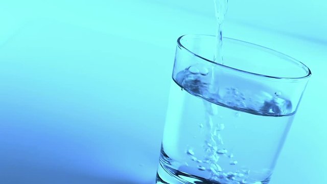 filling a glass with water, nutrition and health-care concept