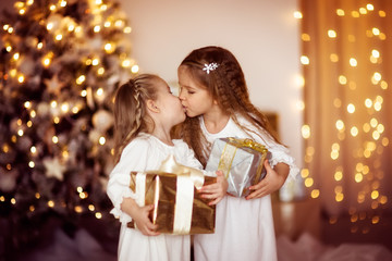 Obraz na płótnie Canvas happy girls sister friends dress white gold background with Ch