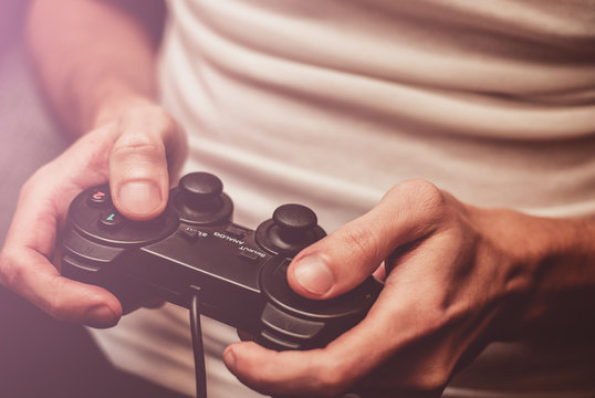 Man playing on the joystick in a game console