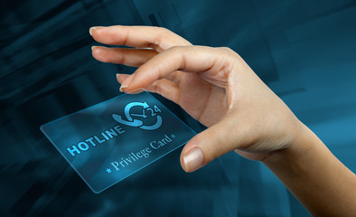 a woman's hand holding  a
digital card with the word hotline
