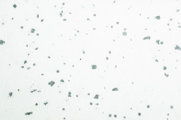 Uneven lighting on the white foam plastic texture with gray points.