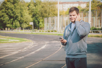 Young man jogging while listening to music