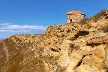 Ancient building on top of the hill and Udabno caves (to the left) , part of rock-hewn Georgian Orthodox monastery complex David Gareja